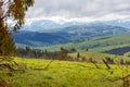 Mountain landscape of spring Carpathians in early spring with low clouds and fresh green grass on the hills Royalty Free Stock Photo