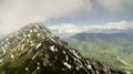 Spring landscape with the mountain peaks covered with snow and clouds Royalty Free Stock Photo