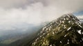 Spring landscape with the mountain peaks covered with snow and clouds Royalty Free Stock Photo