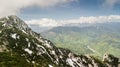 Spring landscape with the mountain peaks covered with snow and clouds Royalty Free Stock Photo