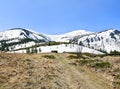 Spring landscape of mountains with hills covered of snow, glade, of fir forest and blue sky. Carpathian mountains Royalty Free Stock Photo