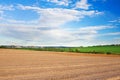Spring of landscape with ploughed field and blue sky Royalty Free Stock Photo