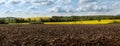 Spring Landscape with Plowed Field on the Background of Beautiful Blue Sky. Ploughed Soil. Agriculture Concept. Copy Space