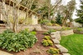 Spring Landscape with retaining walls and garage. Royalty Free Stock Photo
