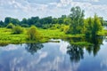 Spring landscape with river and clouds on the blue sky Royalty Free Stock Photo