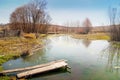 Spring landscape, river with a wooden bridge, fine day_ Royalty Free Stock Photo