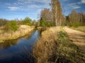 Spring landscape with road and river next to it, the first bright spring greenery Royalty Free Stock Photo