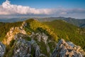 Spring landscape with rocks and wrinkled hills with deep valleys.