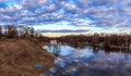 Spring landscape, sky, clouds, temple on the bank of the river flooded Royalty Free Stock Photo