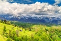 Spring landscape with snowy mountains near Brasov, Transylvania, Romania, Europe Royalty Free Stock Photo