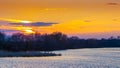 Spring landscape with trees by the river and picturesque sky during sunset Royalty Free Stock Photo