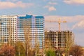 Spring landscape view of the process of building multistorey residential buildings. Building crane and building