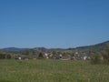 Spring landscape with view on village Cvikov in Lusitian mountains with old and modern houses and lush green grass