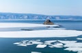 Spring landscape with white ice floes on blue water of Baikal Lake