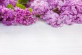 Spring lilac flowers as frame on white wooden table background, copy space Royalty Free Stock Photo