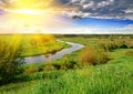 Spring meadow and river in the evening