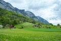 Spring meadows and fields landscape with cottage houses in Switzerland Royalty Free Stock Photo