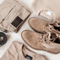 Spring men`s clothing style. Trendy beige trousers with fashionable suede boots with a vintage knitted sweater with a classic