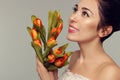 Spring model shooting. Young woman with flowers tulips. Fashion Royalty Free Stock Photo