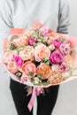 Beautiful luxury bouquet of mixed flowers in woman hand. the work of the florist at a flower shop. Vertical photo Royalty Free Stock Photo