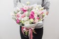 Spring mood. beautiful luxury bouquet of mixed flowers in woman hand. the work of the florist at a flower shop. Horizontal photo Royalty Free Stock Photo