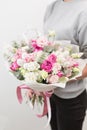 Spring mood. beautiful luxury bouquet of mixed flowers in woman hand. the work of the florist at a flower shop. Vertical Royalty Free Stock Photo