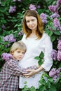 Spring mood, future mother and son relaxing and enjoying life in nature. Royalty Free Stock Photo