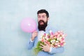 Spring mood. Love date. Gift bouquet. Present for spouse. Guy with air balloon. Birthday party. Bearded man hipster with
