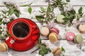 Spring mood, still-life with coffee french macaroons and branches of blossoming apple-tree.