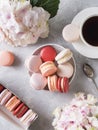 Spring mood still life with macaroons, flowers and cup of coffee