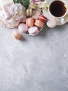 Spring mood still life with macaroons, flowers and cup of coffee