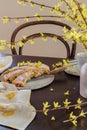 Spring mood table with blooming forsythia branches and home baked apple pie Royalty Free Stock Photo