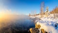Spring morning landscape with fog and a forest on the shore of a lake, Russia, the Urals, February Royalty Free Stock Photo