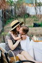 In the spring, mother and daughter spend too much time in the apple orchard. Happy family concept Royalty Free Stock Photo