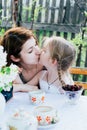 In the spring, mother and daughter spend too much time in the apple orchard. Happy family concept Royalty Free Stock Photo