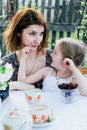 In the spring, mother and daughter spend too much time in the apple orchard. Happy family concept Royalty Free Stock Photo