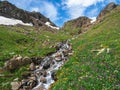 Spring in the mountains, bright natural green alpine highlands background. Eco-friendly green mountain highlands with a winding Royalty Free Stock Photo