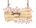 Spring nature background with a pink sakura blossom and wooden sign