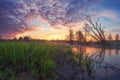 Spring nature landscape in the morning with colorful sky at dawn. Amazing nature on river shore in the sunrise. Vivid illuminated Royalty Free Stock Photo