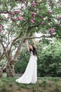 Fashion young woman in long white dress under the tree Royalty Free Stock Photo