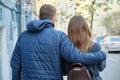 Spring outdoor portrait of young couple walking, attractive man and woman, city street background, back view Royalty Free Stock Photo