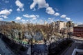 Spring park with stone walkways and benches Moscow on a spring day with clouds.