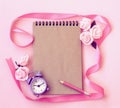 Spring pink background with alarm clock, rose flowers, pencil, n Royalty Free Stock Photo