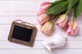 Spring pink tulips, decorative rabbit and empty tag on white Royalty Free Stock Photo