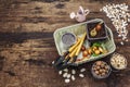 Spring planting and gardening concept. Tools, watering can, fresh onion bulbs in a bucket, expanded clay, sand, seeds. Wooden Royalty Free Stock Photo