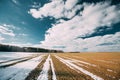 Spring Plowed Field Partly Covered Winter Melting Snow Ready For New Season. Ploughed Field In Early Spring. Farm Royalty Free Stock Photo