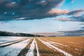 Spring Plowed Field Partly Covered Winter Melting Snow Ready For New Season. Ploughed Field In Early Spring. Farm Royalty Free Stock Photo