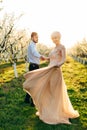 Spring portrait of beautiful happy couple, dancing and spending time in spring blossoming garden. Smiling woman with Royalty Free Stock Photo