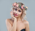 Spring portrait of cheerful woman in flowers crown. Beautiful model with short hair and makeup smiling Royalty Free Stock Photo