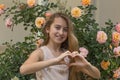 Spring portrait of a girl with long blonde hair posing in front